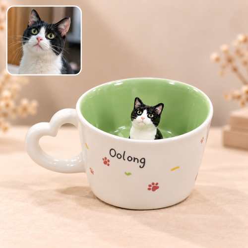 Ceramic mug with heart-shaped handle and raised cat motif